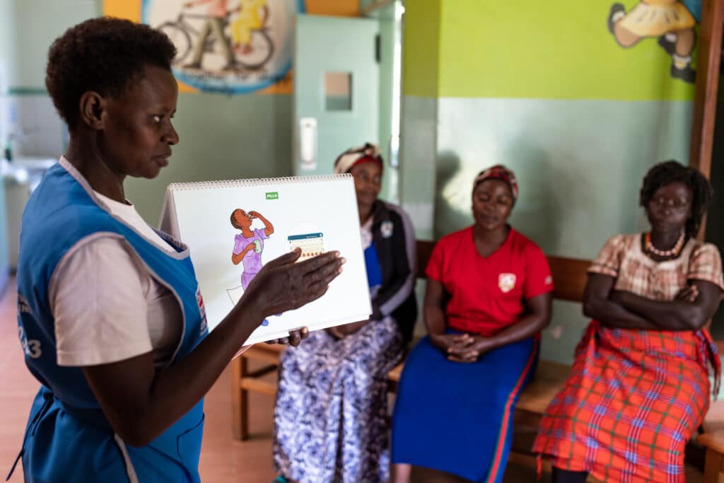A local service provider facilitates a family planning meeting in Kabarole, Uganda.
