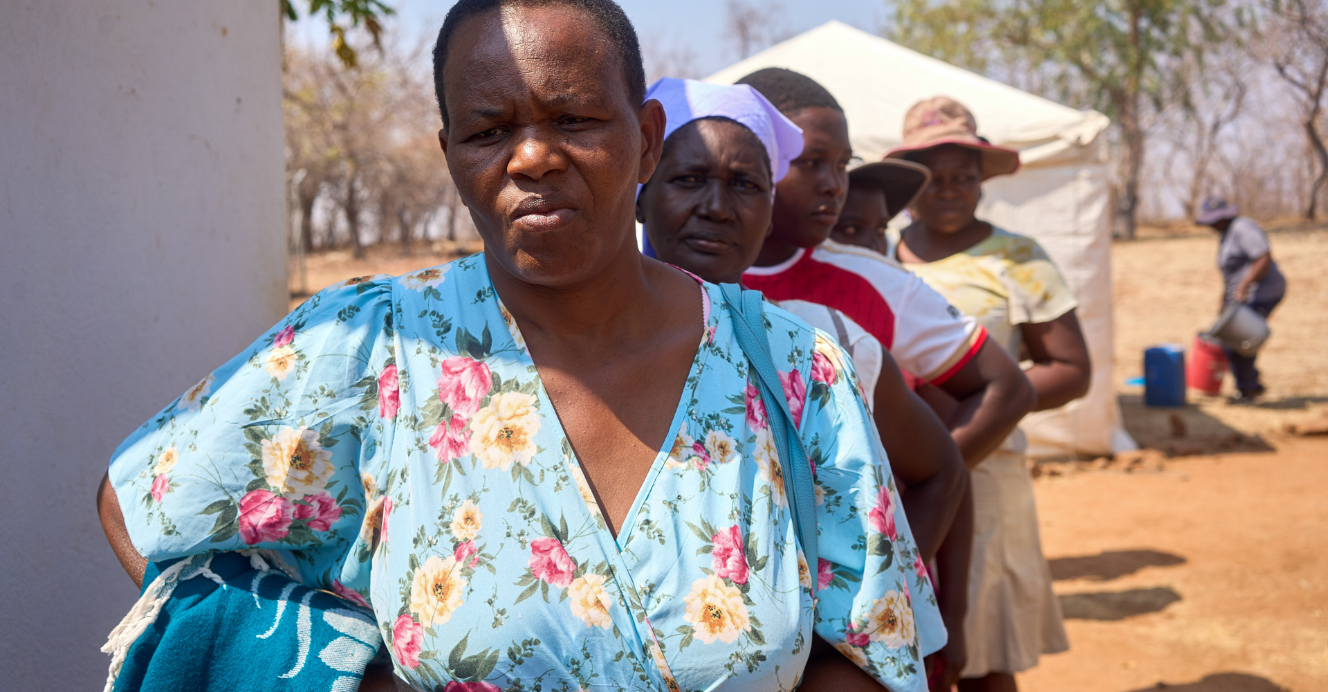 Women line up at the mobile tent for reproductive health services at the clinic in Nyamatikiti, Mashonaland Central Province, Zimbabwe. 19 September 2024..Five of MSI Zimbabwe’s outreach teams are fully funded by USAID. If Donald J. Trump wins the US presidential election for the Republican Party, then it is expected that he will reintroduce the Mexico City Policy or Global Gag Rule as it is known (GGR). The GGR blocks US Government funding for international organisations that deliver, provide information on, advocate for, or even refer people to abortion care. MSI Reproductive Choices has never and will never sign onto this policy, so if Donald J. Trump wins the election, this work in Zimbabwe will likely lose funding and need to stop. If Kamala Harris wins the election for the Democratic Party however, then funding is expected to continue, and these outreach teams will continue to provide essential healthcare services to women and girls in hard-to-reach communities.