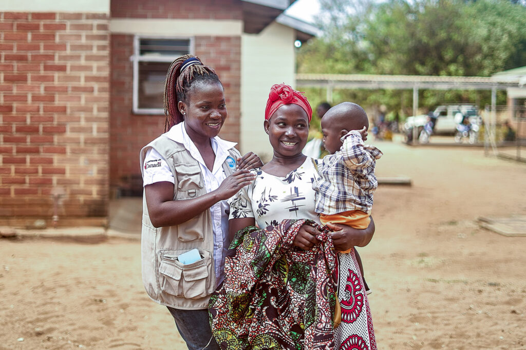 Alinafe Nkhope, a mother of one, holds her son as Idah Savala, an NGO officer, laughs with the infant at Mwansambo Health Clinic in Nkhotakota, Central Region, Malawi. 21 August 2024. The MSI programme in Malawi, called Banja La Mtsogolo (BLM), was established in 1987 to expand access to sexual and reproductive health and rights in Malawi, and support efforts to reduce unsafe abortion and high rates of maternal mortality. Today, BLM is Malawi’s largest non-profit provider of quality sexual and reproductive health services, delivering care across 28 districts and responsible for providing 65% of the country’s contraceptive services. The programme provides all modern methods of short-acting and long-acting reversible contraception (LARCs), permanent contraceptive methods, and post-abortion care, following an unsafe abortion. BLM also provides maternal and child health services, cervical cancer screening, preventive treatment, and testing and treatment of sexually transmitted infections including HIV.