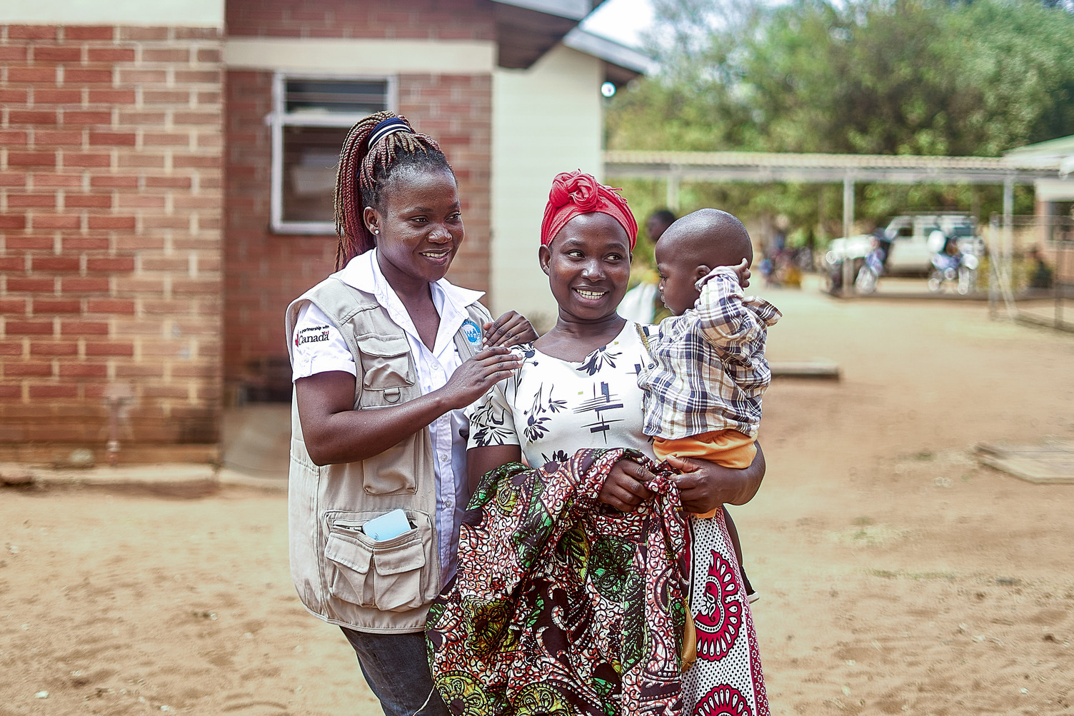 Alinafe Nkhope, a mother of one, holds her son as Idah Savala, an NGO officer, laughs with the infant at Mwansambo Health Clinic in Nkhotakota, Central Region, Malawi. 21 August 2024. The MSI programme in Malawi, called Banja La Mtsogolo (BLM), was established in 1987 to expand access to sexual and reproductive health and rights in Malawi, and support efforts to reduce unsafe abortion and high rates of maternal mortality. Today, BLM is Malawi’s largest non-profit provider of quality sexual and reproductive health services, delivering care across 28 districts and responsible for providing 65% of the country’s contraceptive services. The programme provides all modern methods of short-acting and long-acting reversible contraception (LARCs), permanent contraceptive methods, and post-abortion care, following an unsafe abortion. BLM also provides maternal and child health services, cervical cancer screening, preventive treatment, and testing and treatment of sexually transmitted infections including HIV.