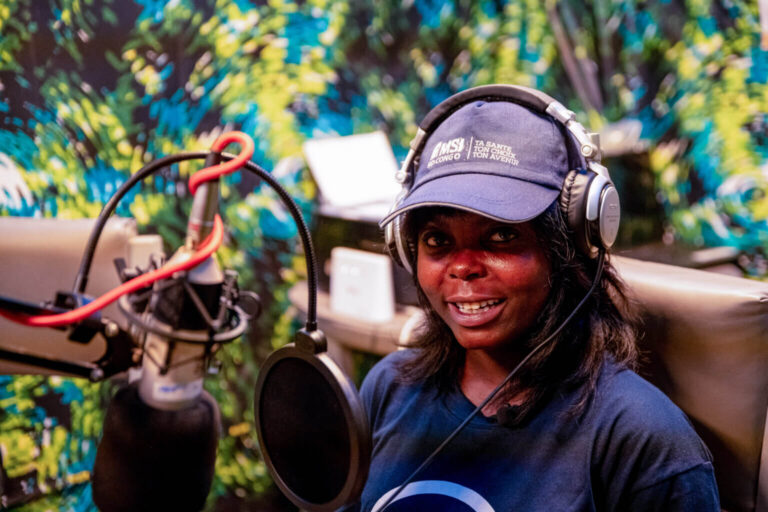A picture of Esther in a purple hat with headphones