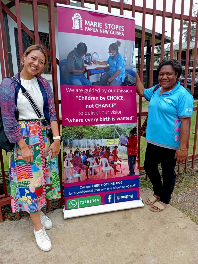 Nancy next to the Marie Stopes PNG sign
